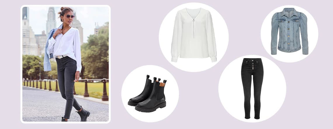 Frau spaziert in der Stadt, trägt weiße Bluse, schwarze Jeans, schwarze Stiefeletten und hellblaue Jeansjacke über der Schulter